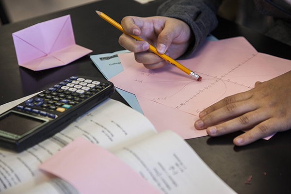 Photo of desk with papers and calculator.